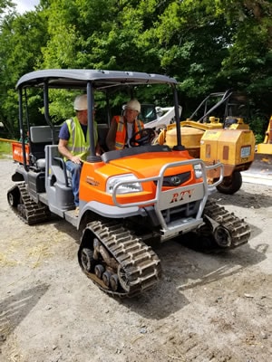 Tuckermans Trails - orange tracked ATV with crew at staging area