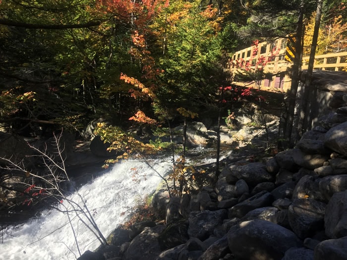 Tuckermans Trails - bridge over rushing stream with fall foliage