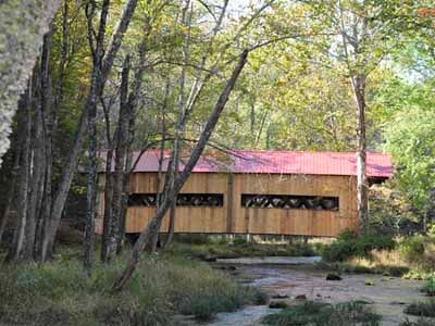 Ashokan covered bridge through trees autumn foliage