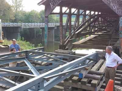 Steel floor beam replacement work on Beechfork covered bridge
