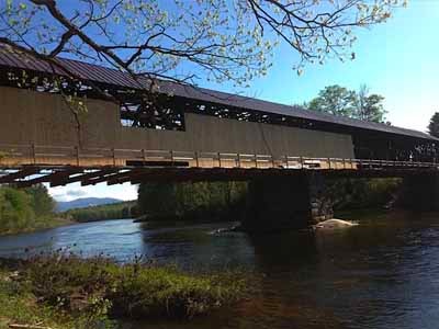 Blair covered bridge completed exterior over river in spring foliage