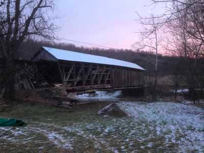 Cabin Creek covered bridge in winter landscape with snow on ground