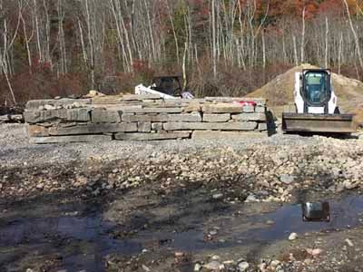 Gold Mine covered bridge exterior with red siding over rocky stream