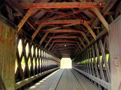 Middle covered bridge interior looking through showing timber truss structure