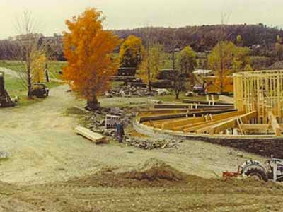 Shelburne round barn construction site in autumn with framing underway